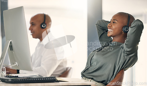 Image of Relax, call center and a happy woman with a headset at computer with a smile for target achievement. Black person crm support agent at pc to finish task for telemarketing, sales or help desk solution