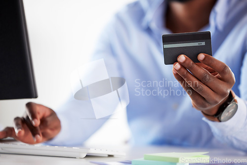 Image of Hand, black man and typing with credit card, office and online shopping with password, discount and payment. African customer, cyber security and e commerce with desktop, pc and fintech in workplace