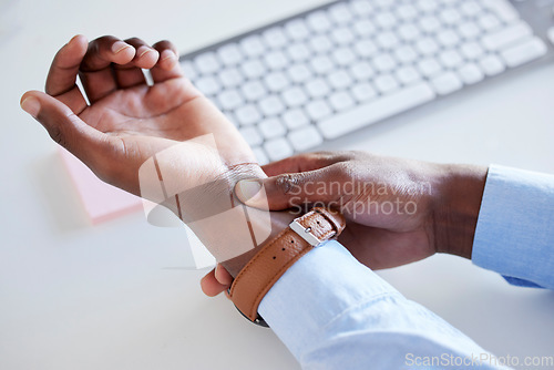 Image of Hand, man and wrist pain in office, keyboard and problem with typing, tired and fatigue with arthritis. African businessman, hands and closeup for nerve, health issue or carpal tunnel in workplace