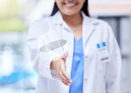 Image of Doctor, open hand shake and woman with welcome, respect or greeting in hospital, hiring and smile. Female medic, handshake and kindness for partnership, recruitment or agreement in clinic office