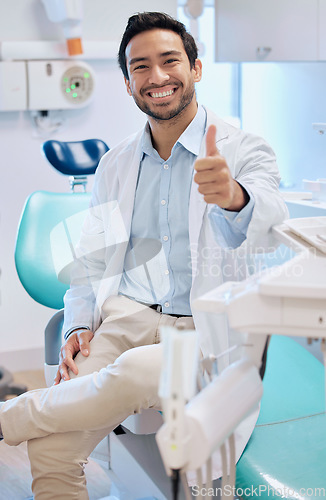 Image of Dentist, thumbs up and portrait of man in office for teeth whitening, service and dental care. Healthcare, dentistry and orthodontist with thank you hand sign for oral hygiene, wellness or cleaning