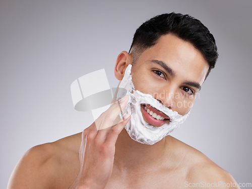 Image of Happy, shaving and foam with portrait of man in studio for hair removal, grooming and skincare. Cosmetics, self care and morning with face of male model on gray background for cleaning and product