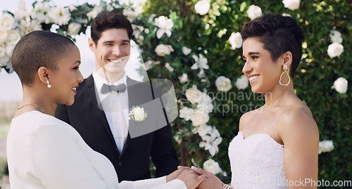 Image of Happy, holding hands and lgbtq with lesbian couple at wedding for celebration, gay and pride. Smile, love and happiness with women at marriage event for partner commitment, sexuality and freedom