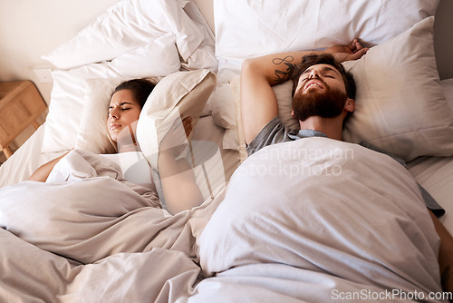 Image of Bed, snoring and sleeping couple, frustrated woman or person with husband noise, problem and cover ears with pillow. Sleep, insomnia and relax girl with fatigue, tired and exhausted in home bedroom