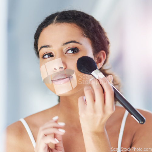 Image of Beauty, self care and woman with a makeup brush for a natural, skin and face in her bathroom. Cosmetic, glamour and beautiful female person with cosmetics powder for morning routine in her apartment.