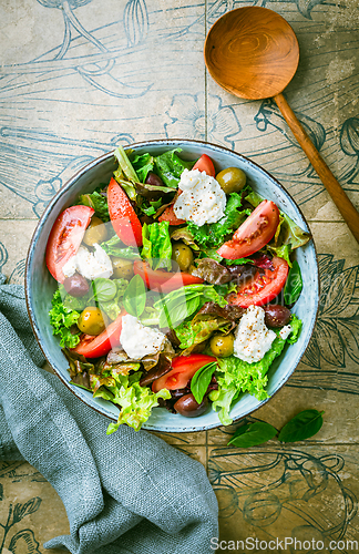 Image of Burrata salad with tomatoes, olives and salad mix