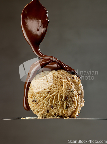 Image of melted chocolate pouring on caramel ice cream