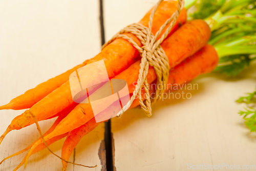 Image of baby carrots bunch tied with rope