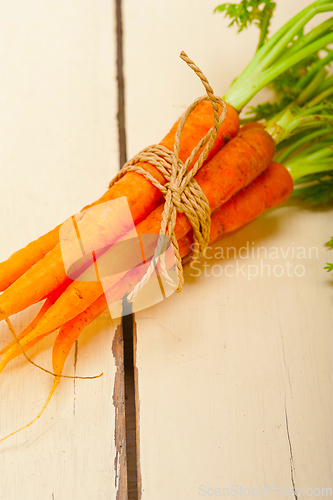 Image of baby carrots bunch tied with rope