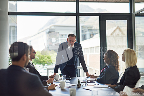 Image of Presentation, man speaker with coworkers and in business meeting in a conference room of their workplace. Brainstorming or planning, ideas or data review and colleagues together in modern office