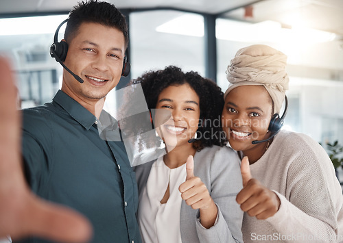 Image of Selfie, thumbs up and call center friends in the office, posing for a photograph together in a customer service workplace. Portrait, motivation and support with consultant colleagues taking a picture