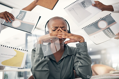 Image of Anxiety, business and black woman with stress, multitasking and annual report deadline with a headache. Female person, consultant and agent with a migraine, chaos and headphones with documents or crm