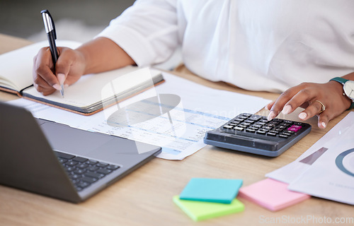 Image of Budget, accountant with calculator and notebook with laptop calculating finance in a modern office. Financial planning or audit, accounting or expenses and female person working at workspace