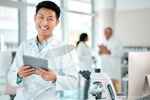 Image of Tablet, asian man and portrait of a scientist in laboratory, hospital or science research for medicine, chemistry or innovation. Doctor, technology and medical worker with smile in clinic or lab