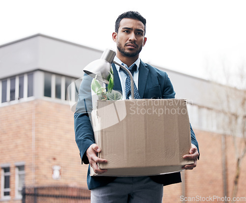 Image of Box, recession and a fired business man walking outdoor in the city with stress of problem. Financial crisis, depression and unemployment with a young male employee looking sad in an urban street