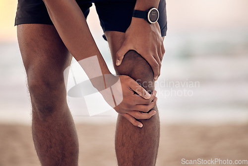 Image of Knee injury, man hand and beach fitness with training, exercise and workout accident outdoor. Sea, ocean and male person holding leg from pain from run in nature with muscle strain and inflammation