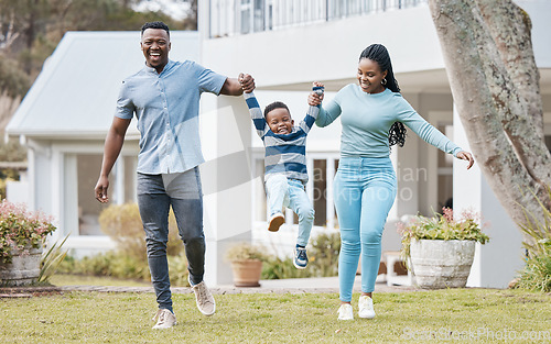 Image of Happy parents lifting their kid by their new home in the outdoor garden while playing together. Backyard, bonding and African mother and father holding their boy child in the backyard of their house.