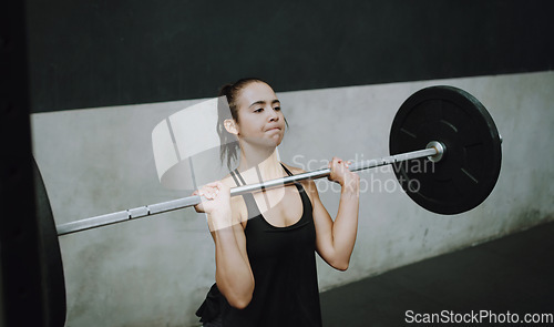 Image of Weightlifting, fitness and woman lifting barbell in gym for training, exercise and intense workout. Deadlift, strong muscle and female body builder lift weights for challenge, wellness and strength