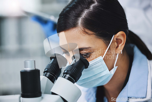 Image of Science, face mask and woman with microscope for medical analysis, research and lab test. Laboratory, biotechnology and female scientists with equipment for sample, experiment and examine virus