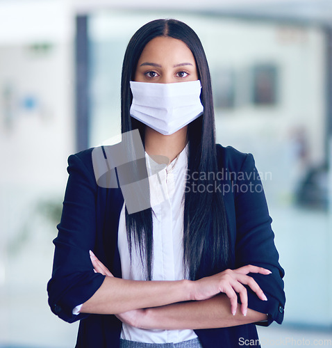 Image of Business woman, face mask portrait and arms crossed with company attorney and serious. Worker, young female employee and professional lawyer in law firm at office with modern office and safety