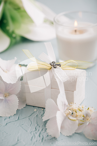 Image of Confirmation or First holy communion concept  - small present with candle and flowers