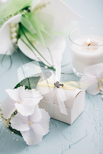 Image of Confirmation or First holy communion concept  - small present with candle and flowers