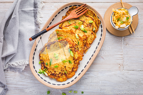 Image of Homemade potato pancakes with cabbage salad and green onions