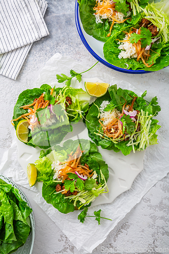 Image of Asian minced meat lettuce wraps with rice, bean sprouts and cabbage