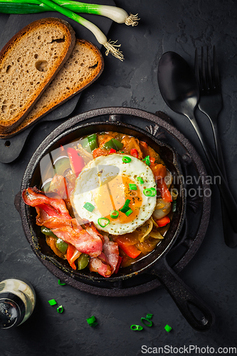 Image of Letscho - tasty Hungarian vegetable stew with peppers, tomatoes  and onions, served with bacon and fried egg