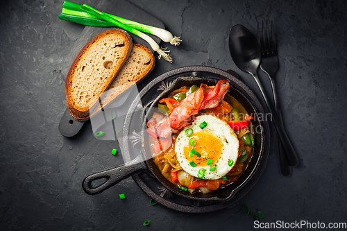 Image of Letscho - tasty Hungarian vegetable stew with peppers, tomatoes  and onions, served with bacon and fried egg