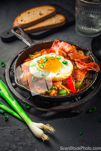 Image of Letscho - tasty Hungarian vegetable stew with peppers, tomatoes  and onions, served with bacon and fried egg