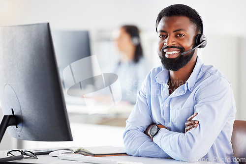 Image of Black man, call center portrait and arms crossed in office for contact us, tech support or microphone. African guy, telemarketing and happy for sales consulting, customer service or help desk for crm