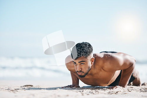 Image of Man, beach and pushup on sand for fitness, workout or exercise for mockup space in summer sunshine. Young guy, bodybuilder and training for health, wellness and strong body with sea mock up on ground