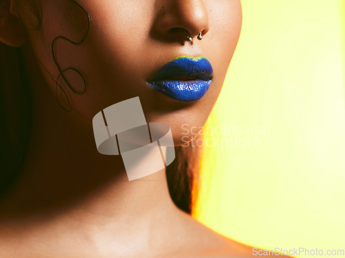 Image of Makeup, blue lipstick and lips of woman in studio for cosmetics, eye shadow and beauty salon. Creative aesthetic, cosmetology and face zoom of female person for glamour, luxury style and skin glow