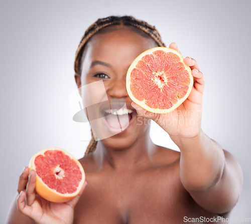 Image of Beauty, grapefruit and skincare with black woman in studio for natural, cosmetics and vitamin c. Nutrition, diet and detox with female model on grey background for citrus fruit and health product