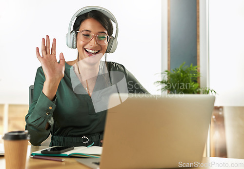 Image of Virtual meeting, business woman and happy wave on a video call with headphones and greeting. Laptop, working and female employee with company webinar and computer with digital communication at office
