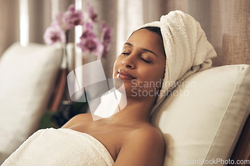 Image of Spa, woman and relax with eyes closed for calm, zen and peace for physical therapy, health and wellness. Female customer with smile, luxury and towel for a holistic massage and hospitality at a salon