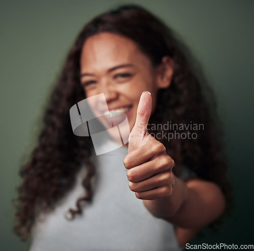 Image of Woman, thumbs up and hand gesture with emoji and agreement, approval and feedback isolated on green background. Yes, like and thank you with happy female person, OK sign and support closeup in studio