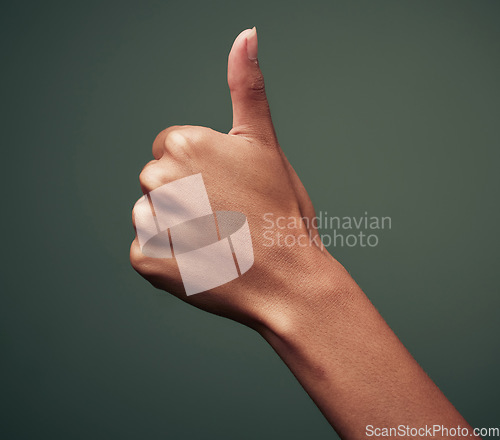 Image of Thumbs up, hand gesture with emoji and agreement, person with approval and feedback isolated on green background. Yes, like and thank you, mockup space with OK sign and support closeup in studio