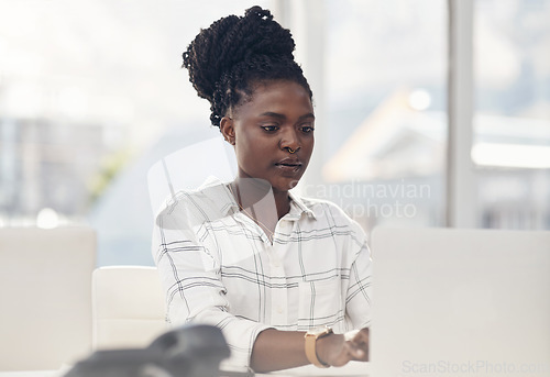 Image of Professional, woman and working on a laptop for a startup in Africa with information technology. Business, female person and focus on the computer for online search with creative idea for a project.