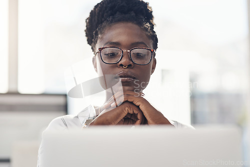 Image of Thinking, decision and business woman on computer for solution, research and serious, focus or job planning. Reading, review and choice of african person or analyst on laptop for data problem solving