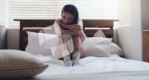 Image of Depression, stress and woman in a bed thinking of problem, sad or mental health in her home. Anxiety, fear and female person with ptsd, grief or broken heart, lonely and paranoid in a bedroom