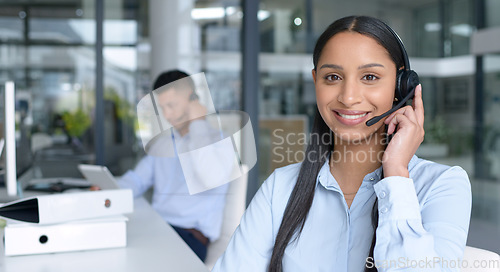 Image of Woman in portrait, smile and call center with CRM, contact us and communication with headset at office. Happy female consultant in customer service, telemarketing or tech support with help desk job