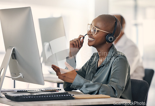 Image of Call center, talking and a happy woman with headset at computer for customer service or crm. Black person support agent at pc for account information, promotion or sale for telemarketing or help desk