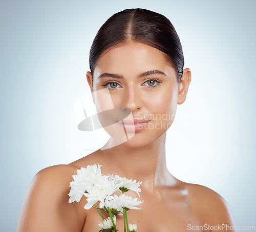 Image of Skincare, face and woman with daisy flower in studio isolated on a white background. Portrait, natural plant and female model with spring floral for makeup cosmetics, beauty treatment and wellness.