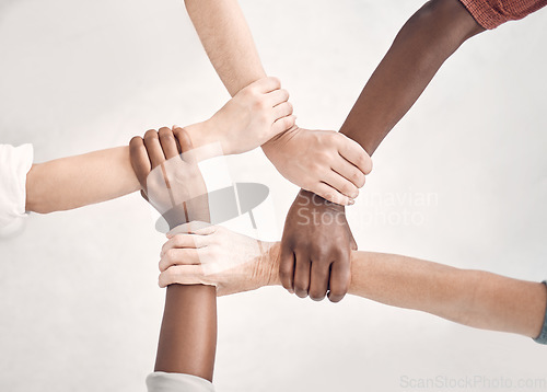 Image of Teamwork, hands of people together with support for strategy and planning with collaboration at start up. Trust in team, coworking and diversity, hand to wrist circle with employees in cooperation.