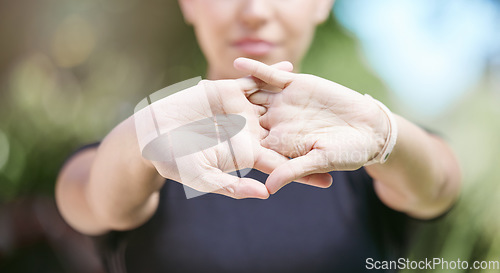 Image of Fitness, runner or person stretching hands for workout or body movement while relaxing on break. Closeup, hand or blurry athlete in exercise training warm up for flexibility or wrist mobility in park