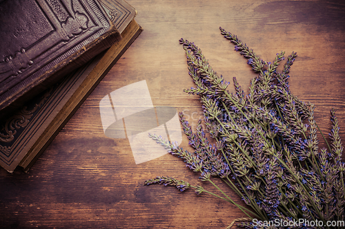 Image of Vintage background with bunch of lavender a old books on wooden background