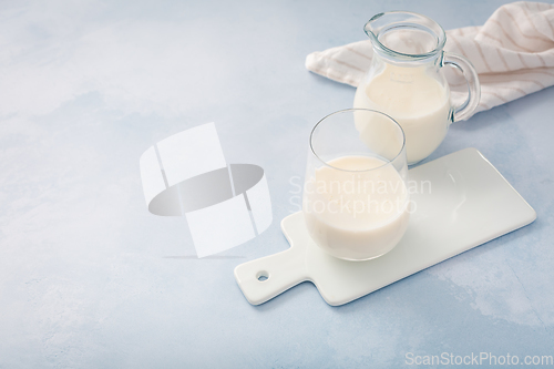 Image of Buttermilk, kefir, yogurt with probiotics, ayran in glass and jar. Probiotic cold fermented dairy drink.