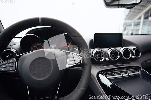 Image of Control buttons on steering wheel. Car interior.